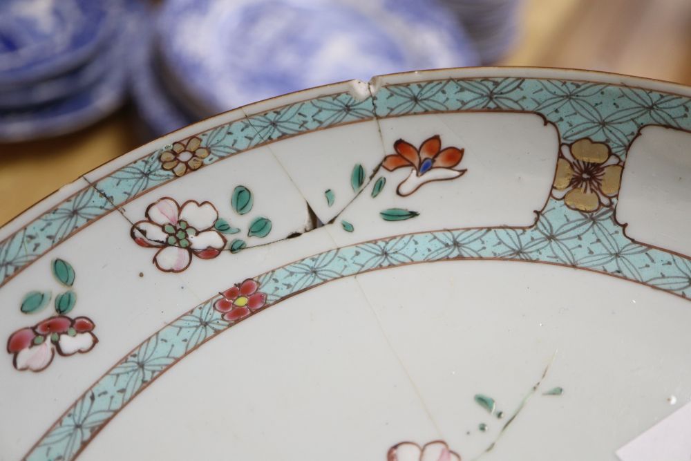 An early 19th century Chinese floral plate, a Chinese blue and white plate and meat platter, together with two other dishes